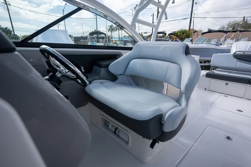 Slide: The Image of 2025 Robalo R317 boat interior with sleek steering and comfortable seating. - 11