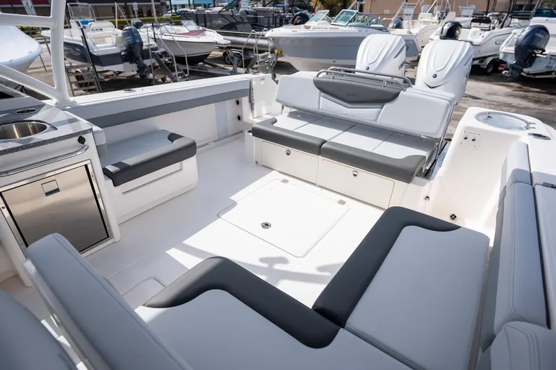 Slide: The Image of 2025 Robalo R317 boat interior with seating and kitchenette, showcasing modern design and functionality. - 13