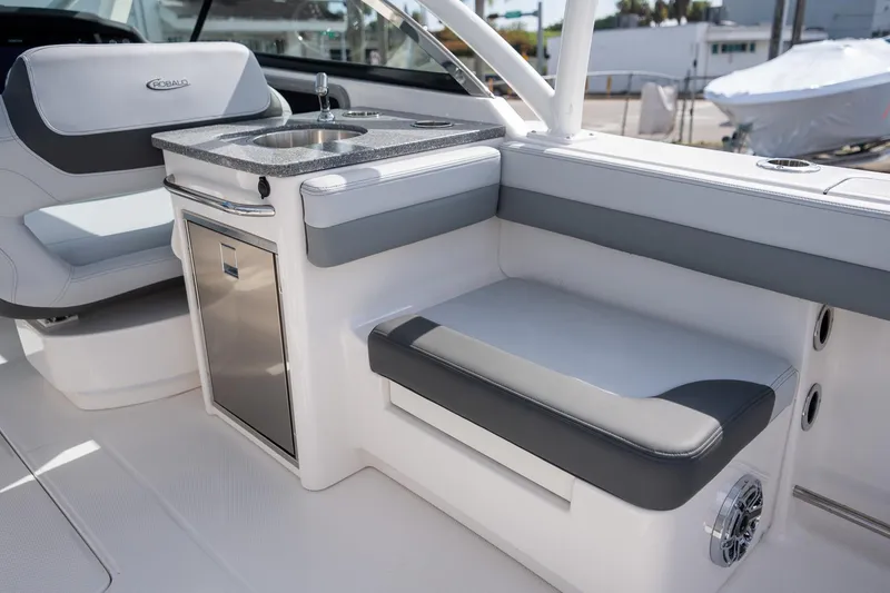 Slide: The Image of 2025 Robalo R317 boat interior with seating and sink area. - 14