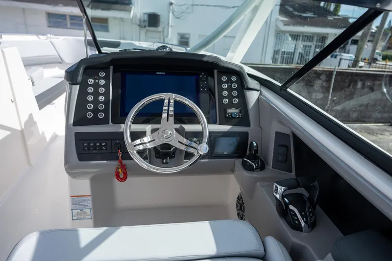 Slide: The Image of 2025 Robalo R317 boat dashboard with modern steering and control panel. - 15