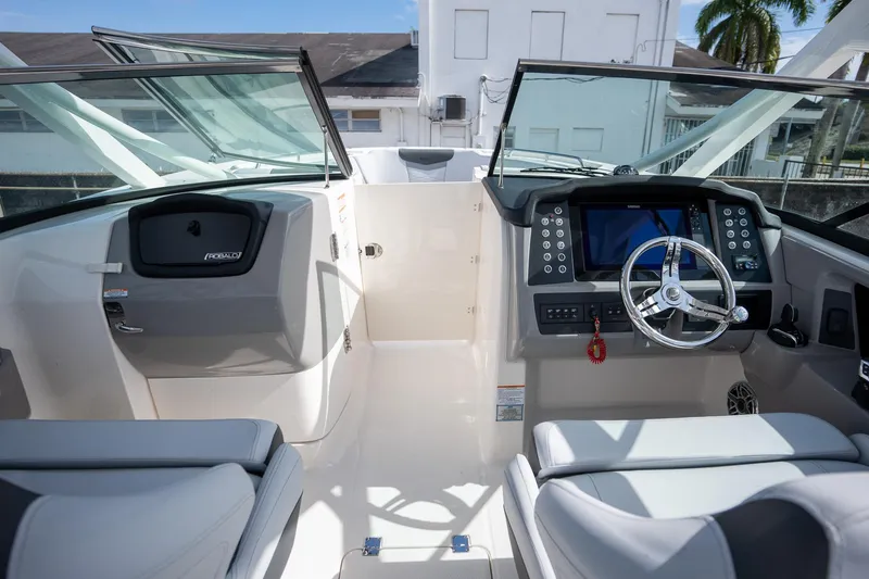 Slide: The Image of 2025 Robalo R317 boat cockpit with modern steering and dashboard controls. - 18