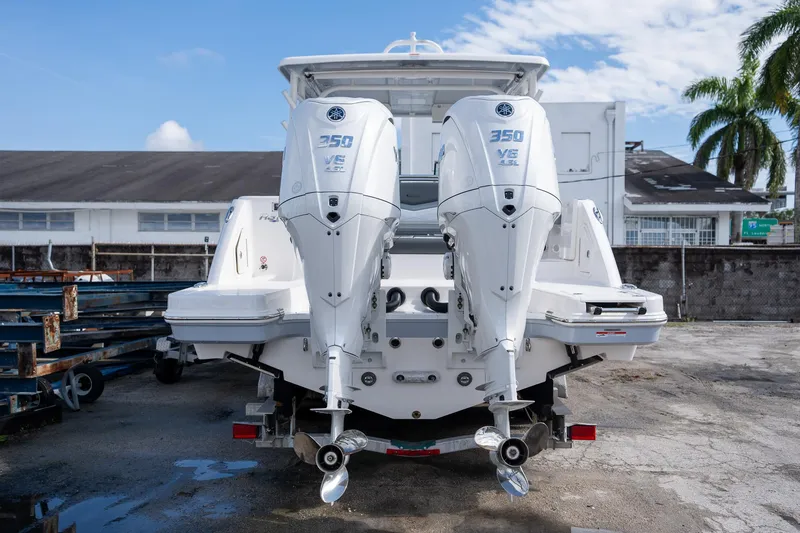 Slide: The Image of 2025 Robalo R317 boat with twin 350 V6 engines, parked outdoors. - 24