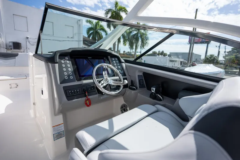 Slide: The Image of 2025 Robalo R317 boat cockpit with modern steering and navigation system. - 3