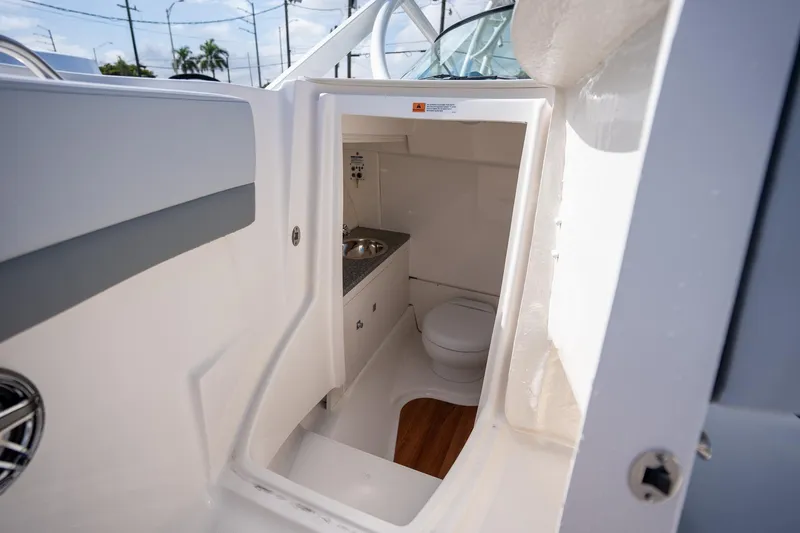 Slide: The Image of 2025 Robalo R317 boat interior bathroom with sink and toilet. - 8