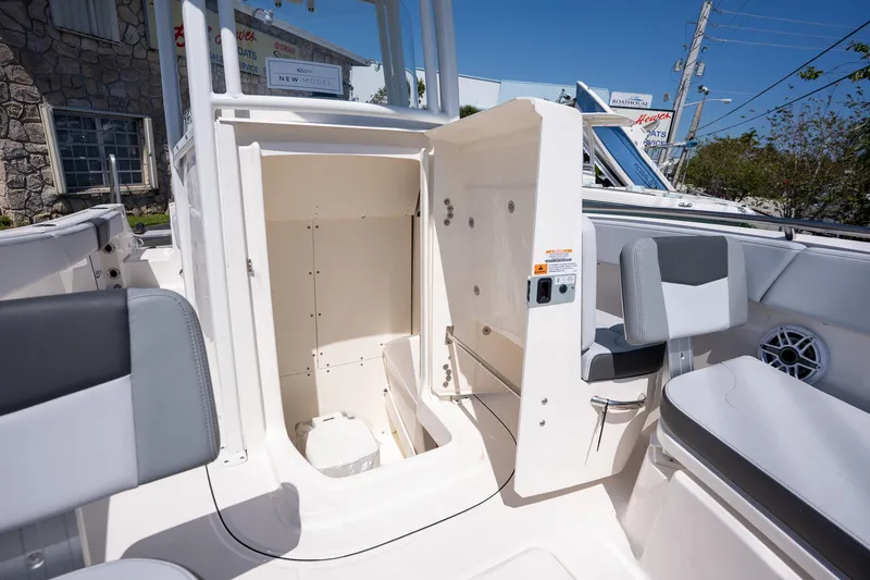 Slide: The Image of 2025 Robalo R230 boat interior with open storage compartment and seating. - 10