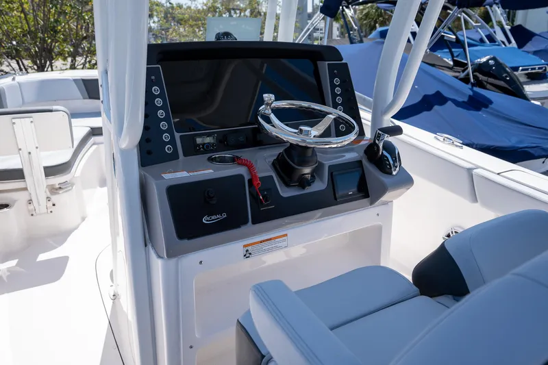Slide: The Image of 2025 Robalo R230 boat cockpit with modern steering and control panel. - 11