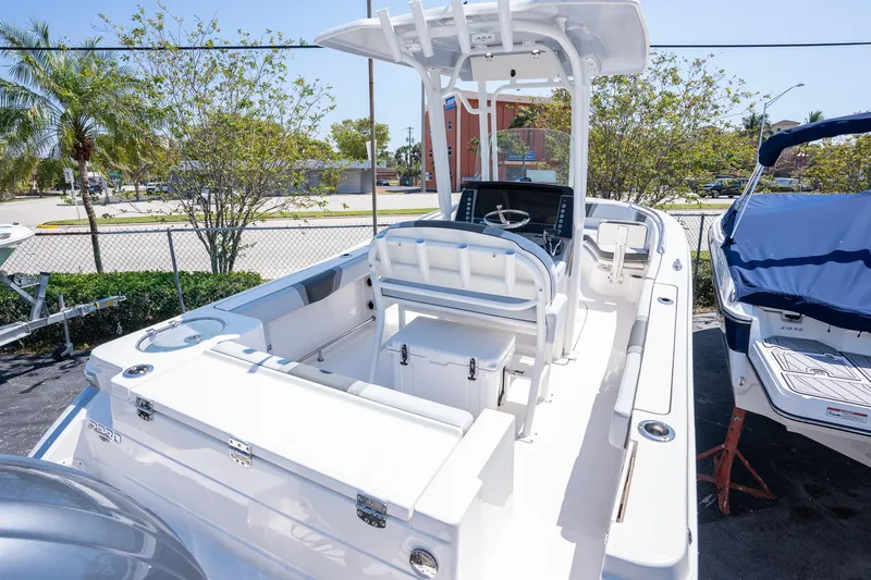 Slide: The Image of 2025 Robalo R230 boat with sleek design, spacious deck, and modern console. - 15