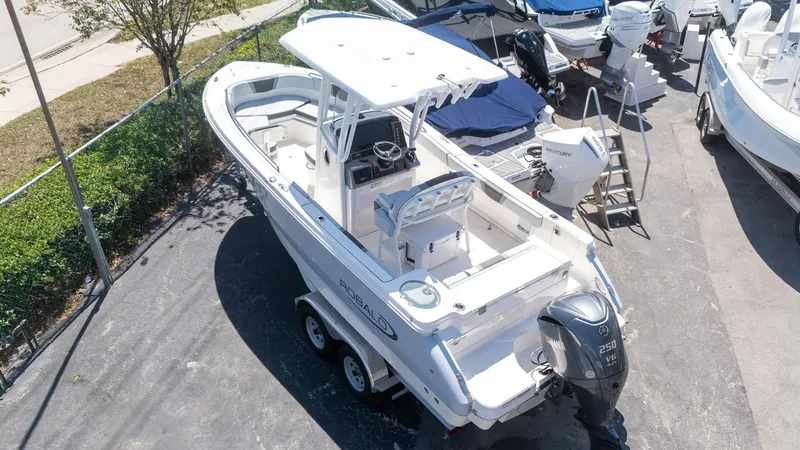Slide: The Image of 2025 Robalo R230 boat on trailer, featuring Yamaha 250 V6 engine, parked outdoors. - 3