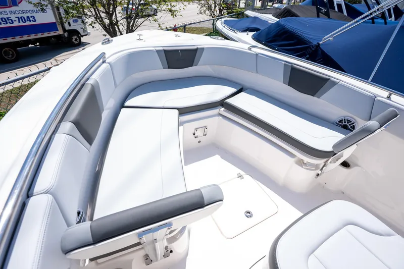 Slide: The Image of 2025 Robalo R230 boat interior with sleek white seating and modern design. - 6