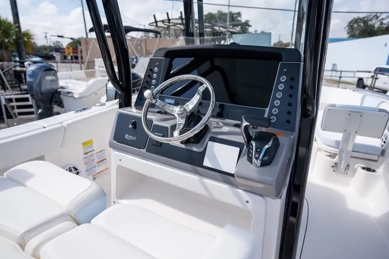 Slide: The Image of 2025 Robalo R230 boat cockpit with modern steering and control panel. - 11