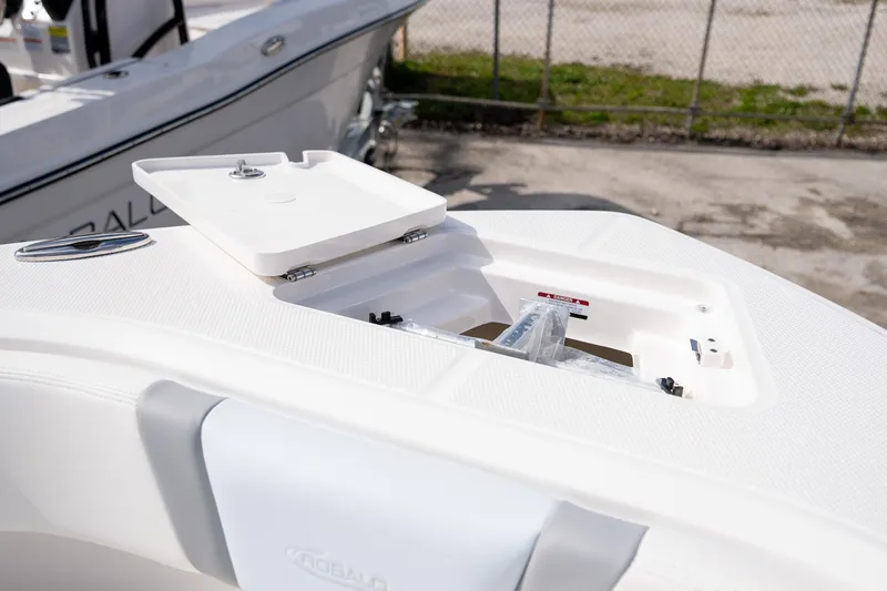 Slide: The Image of 2025 Robalo R230 boat deck with open storage compartment. - 6