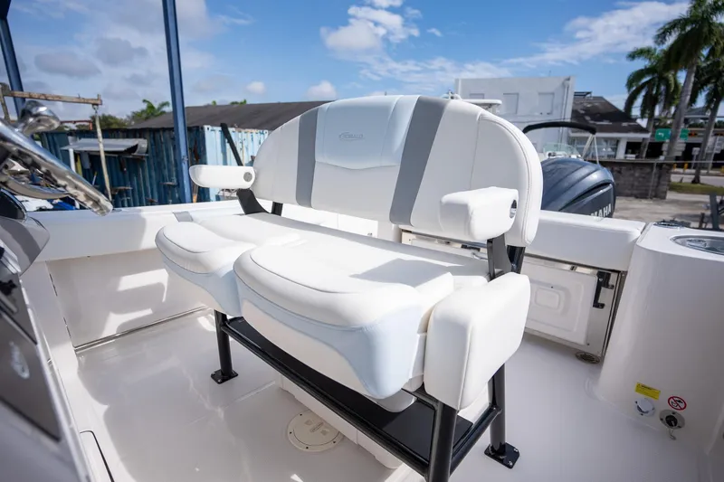 Slide: The Image of 2025 Robalo R230 boat interior with white seating and steering wheel. - 9