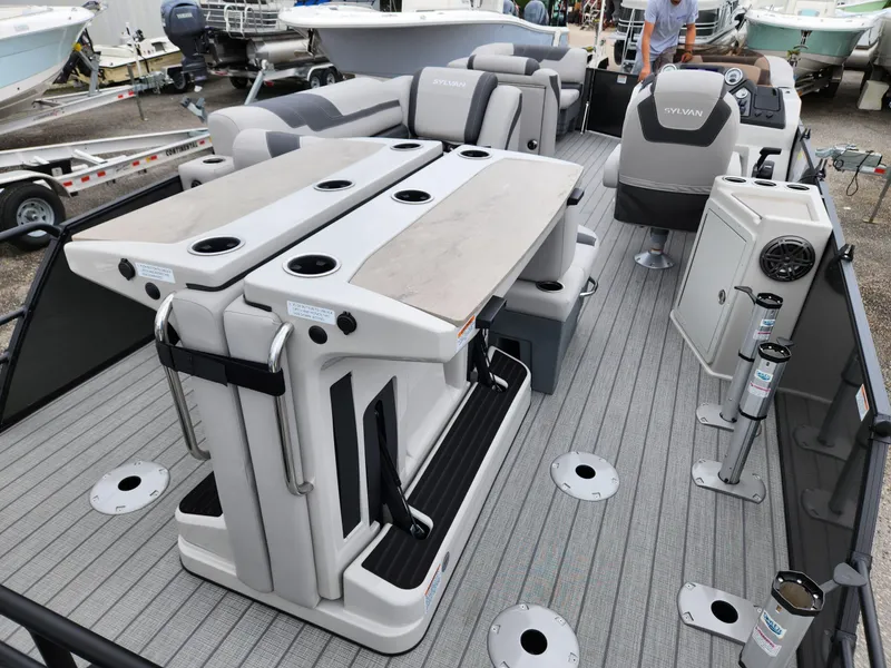 Slide: The Image of 2024 Sylvan L3 DLZ Bar pontoon boat interior with seating and bar area. - 4