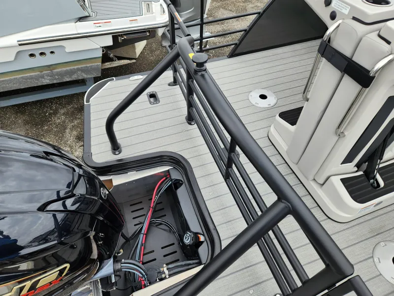 Slide: The Image of 2024 Sylvan L3 DLZ Bar boat deck with motor and seating area. - 5