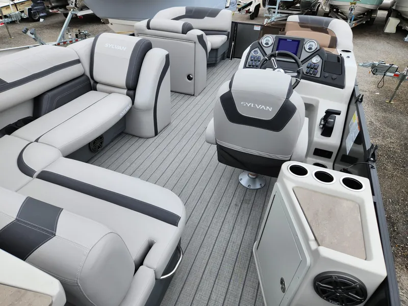 Slide: The Image of 2024 Sylvan L3 DLZ Bar pontoon boat interior with plush seating and modern dashboard. - 8
