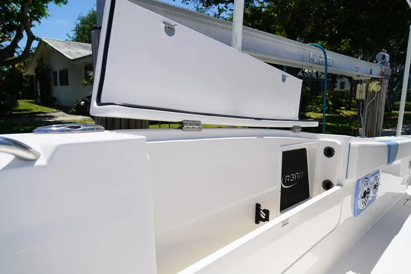 Slide: The Image of 2024 Robalo R360 boat interior with open storage compartment and sleek design. - 22