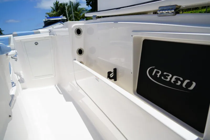 Slide: The Image of 2024 Robalo R360 boat interior with sleek white design and storage compartments. - 24