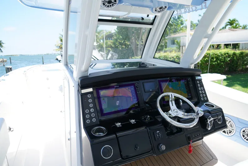 Slide: The Image of 2024 Robalo R360 boat cockpit with advanced navigation displays and sleek steering wheel. - 29