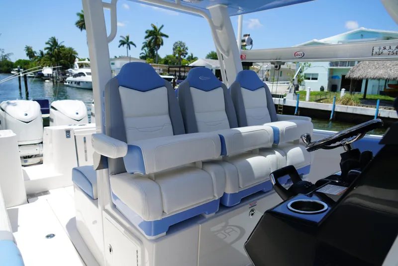 Slide: The Image of 2024 Robalo R360 boat interior with luxurious seating and modern helm controls. - 33