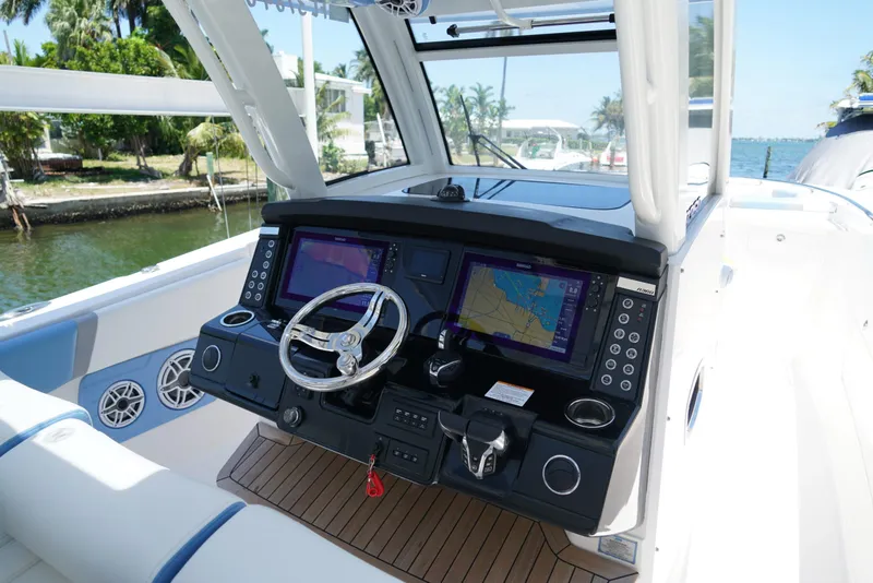 Slide: The Image of 2024 Robalo R360 boat cockpit with dual navigation screens and modern steering wheel. - 36