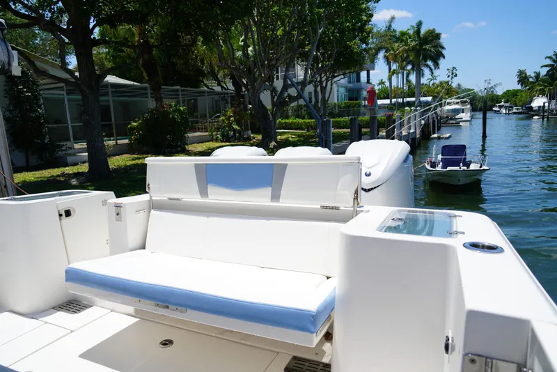Slide: The Image of 2024 Robalo R360 boat with seating, docked by a scenic waterfront. - 43
