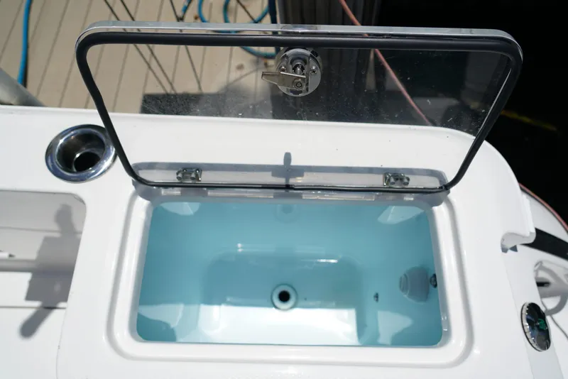 Slide: The Image of Open livewell on 2024 Robalo R360 boat, showcasing interior and lid design. - 44