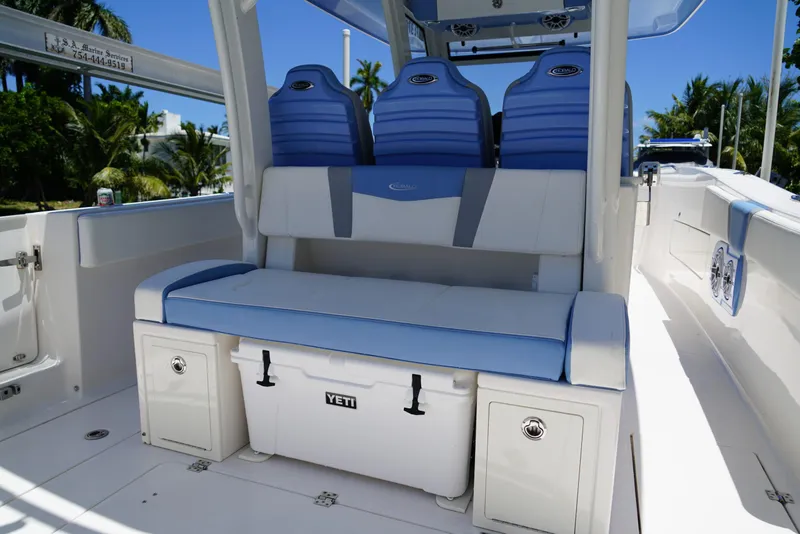 Slide: The Image of 2024 Robalo R360 boat interior with blue seating and Yeti cooler. - 45