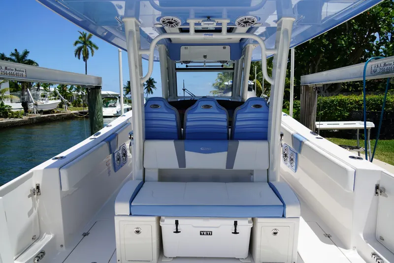 Slide: The Image of 2024 Robalo R360 boat interior with blue seating and Yeti cooler. - 49