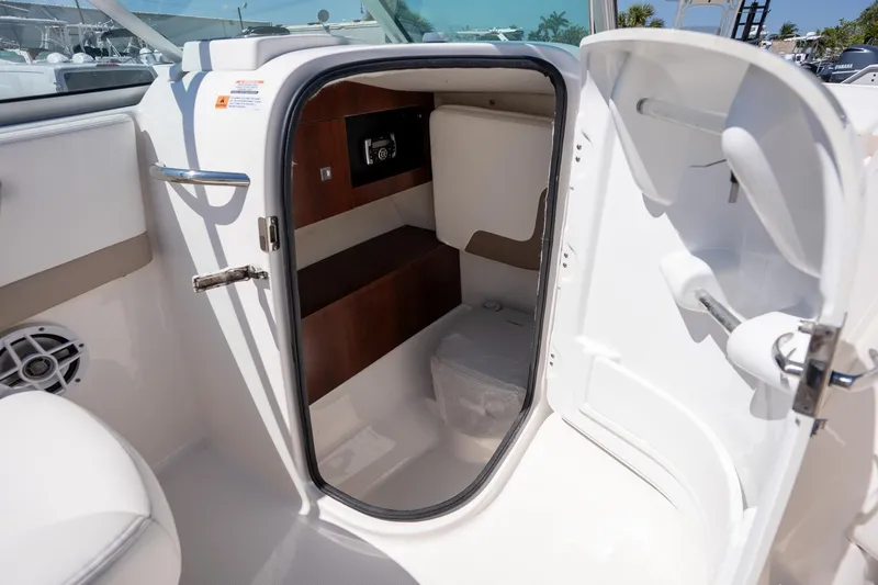 Slide: The Image of 2023 Robalo R227 boat interior cabin with storage and seating area. - 10
