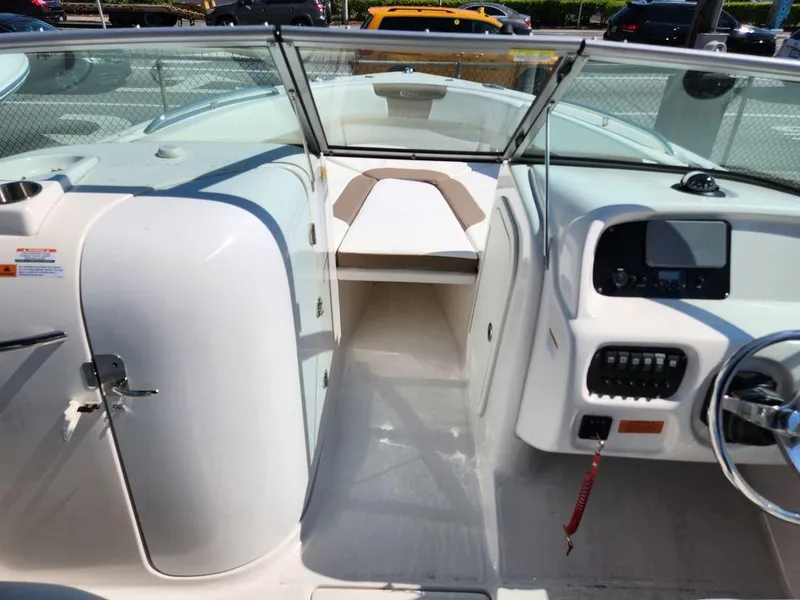 Slide: The Image of 2023 Robalo R227 boat interior with steering console and seating area. - 12