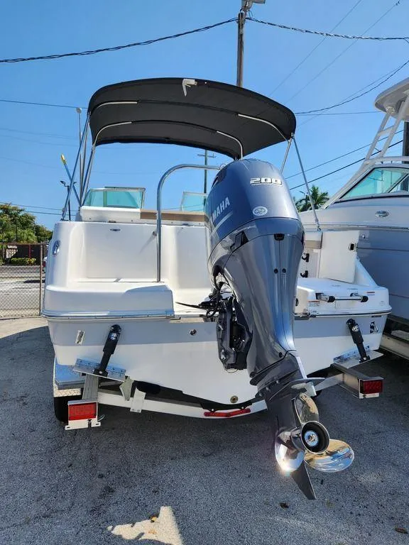 Slide: The Image of 2023 Robalo R227 boat with Yamaha outboard motor, parked on a trailer. - 14