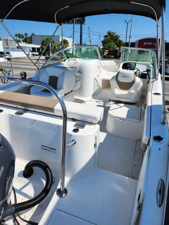 Slide: The Image of 2023 Robalo R227 boat interior with seating and steering wheel under a canopy. - 17