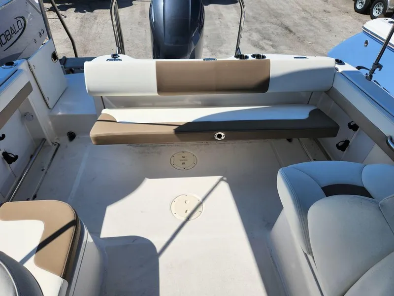 Slide: The Image of 2023 Robalo R227 boat interior with seating and engine view. - 19