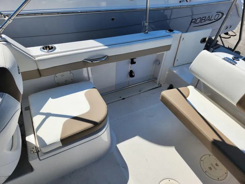 Slide: The Image of 2023 Robalo R227 boat interior with beige and white seating. - 20