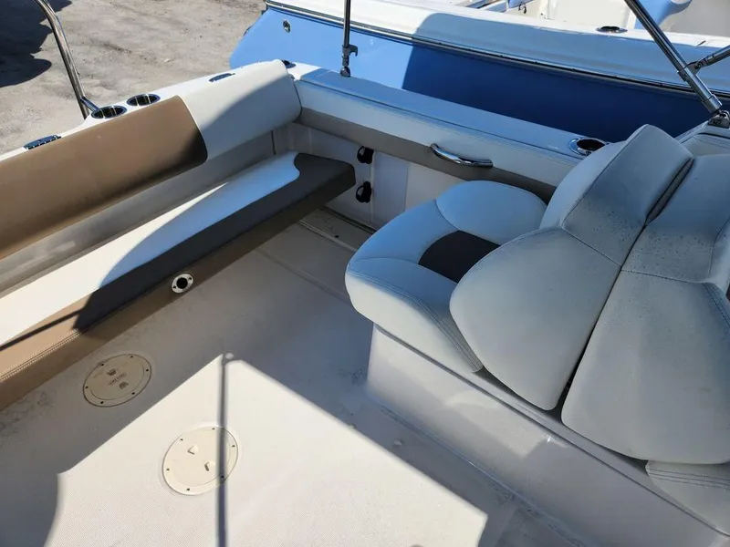 Slide: The Image of 2023 Robalo R227 boat interior with cushioned seating and storage compartments. - 21