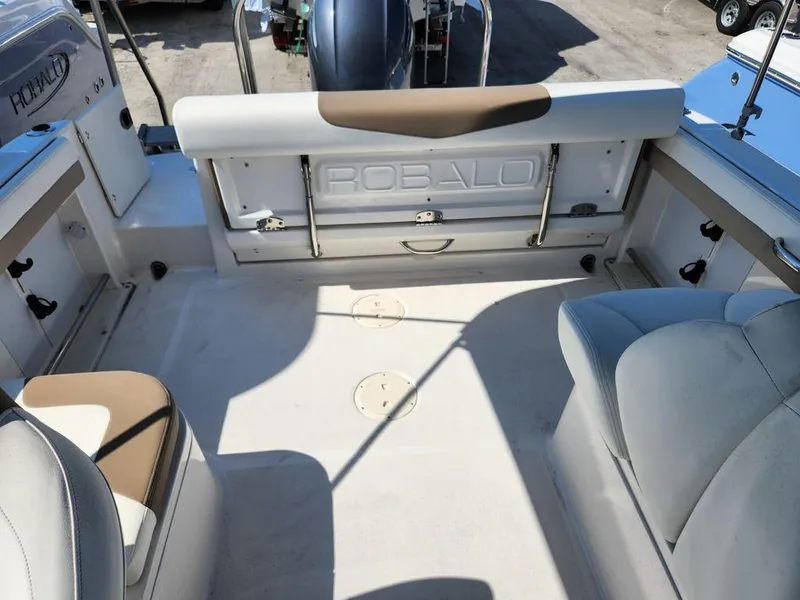 Slide: The Image of 2023 Robalo R227 boat interior with seating and storage compartments. - 22