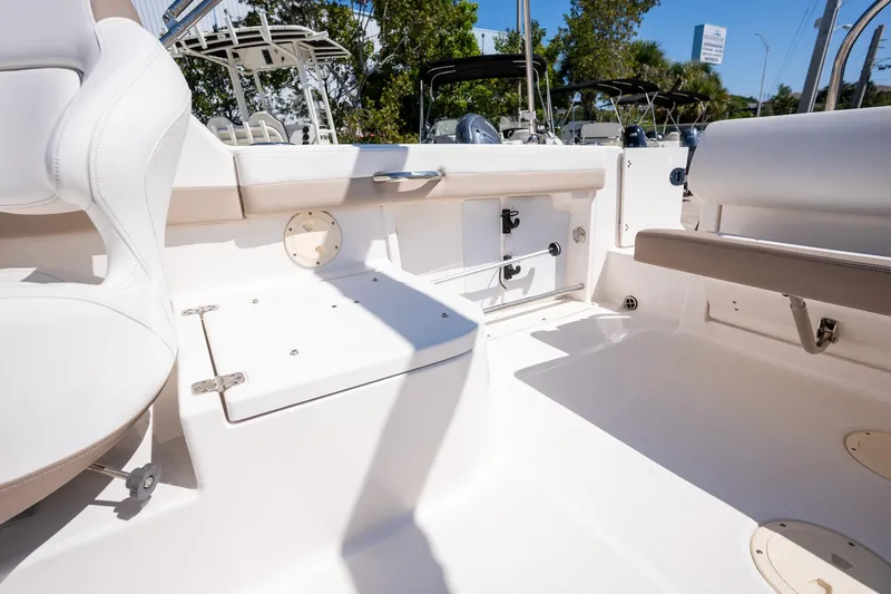 Slide: The Image of 2023 Robalo R227 boat interior with white seating and storage compartments. - 23