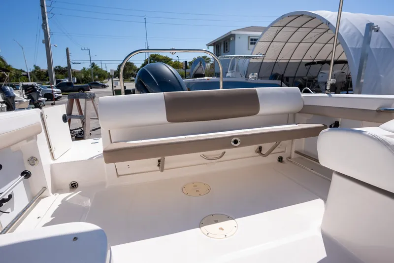 Slide: The Image of 2023 Robalo R227 boat interior with seating and engine view. - 24