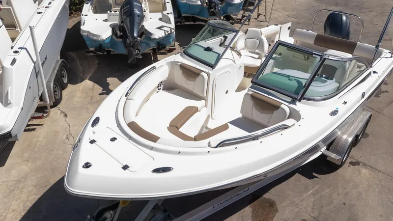 Slide: The Image of 2023 Robalo R227 boat on trailer, featuring spacious seating and sleek design. - 25