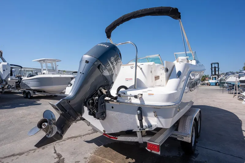 Slide: The Image of 2023 Robalo R227 boat with Yamaha outboard motor on trailer, parked outdoors. - 28