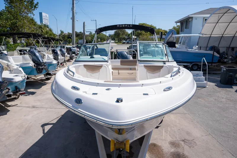 Slide: The Image of 2023 Robalo R227 boat displayed at a marina, surrounded by other boats. - 29