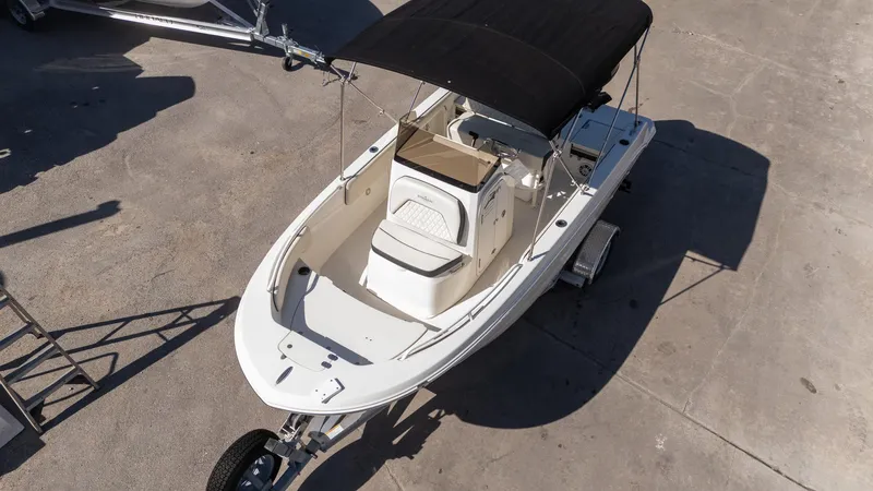 Slide: The Image of 2023 Stingray 173CC boat with black canopy on trailer, viewed from above. - 4