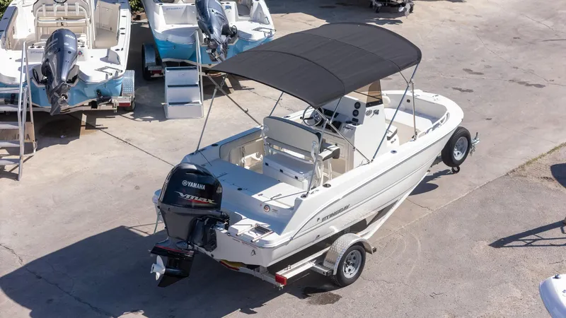 Slide: The Image of 2023 Stingray 173CC boat with Yamaha engine on trailer, parked outdoors. - 5