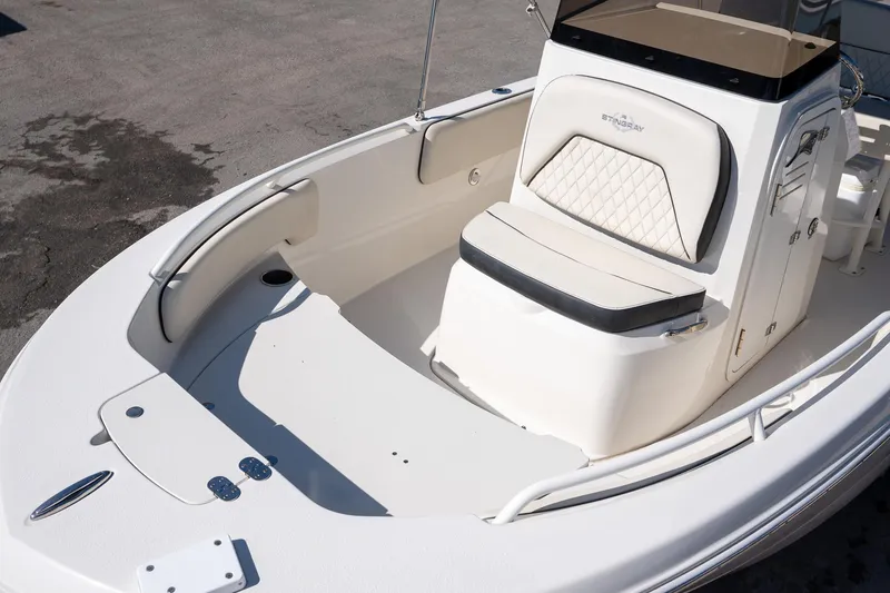 Slide: The Image of 2023 Stingray 173CC boat interior with cushioned seating and storage compartments. - 6