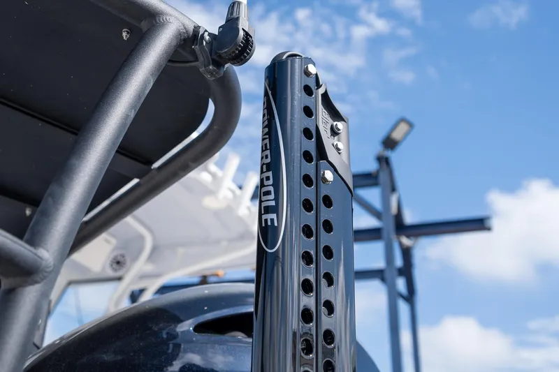 Slide: The Image of 2025 Hewes Redfisher 18 boat with Power-Pole anchor against blue sky. - 11