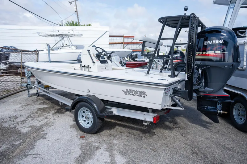 Slide: The Image of 2025 Hewes Redfisher 18 boat on trailer with Yamaha outboard motor. - 2