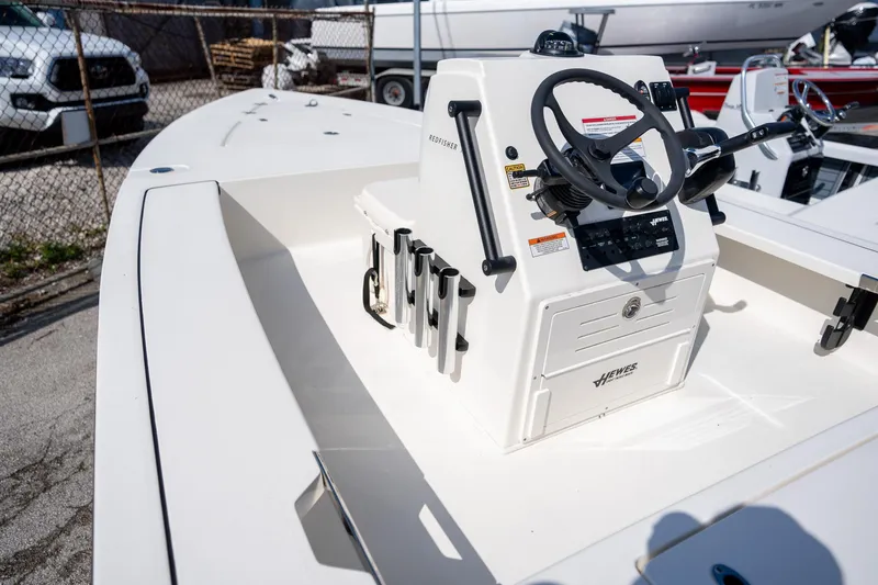 Slide: The Image of 2025 Hewes Redfisher 18 boat console with steering wheel and controls. - 7
