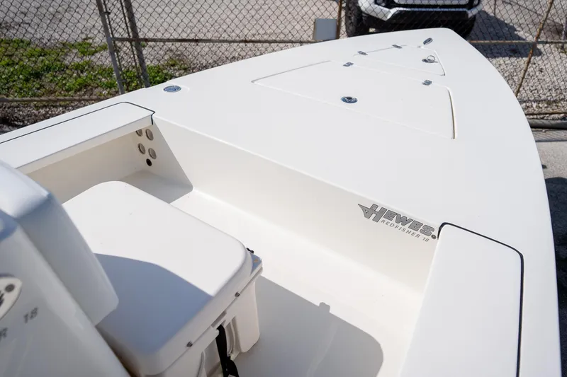 Slide: The Image of 2025 Hewes Redfisher 18 boat deck, featuring sleek design and storage compartments. - 8