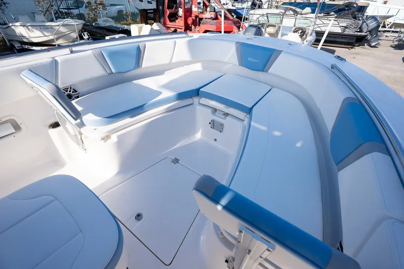 Slide: The Image of 2025 Robalo R250 boat interior with white and blue seating, spacious layout. - 12