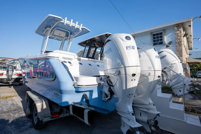 Slide: The Image of 2025 Robalo R250 boat with Yamaha 150 engines on a trailer. - 5